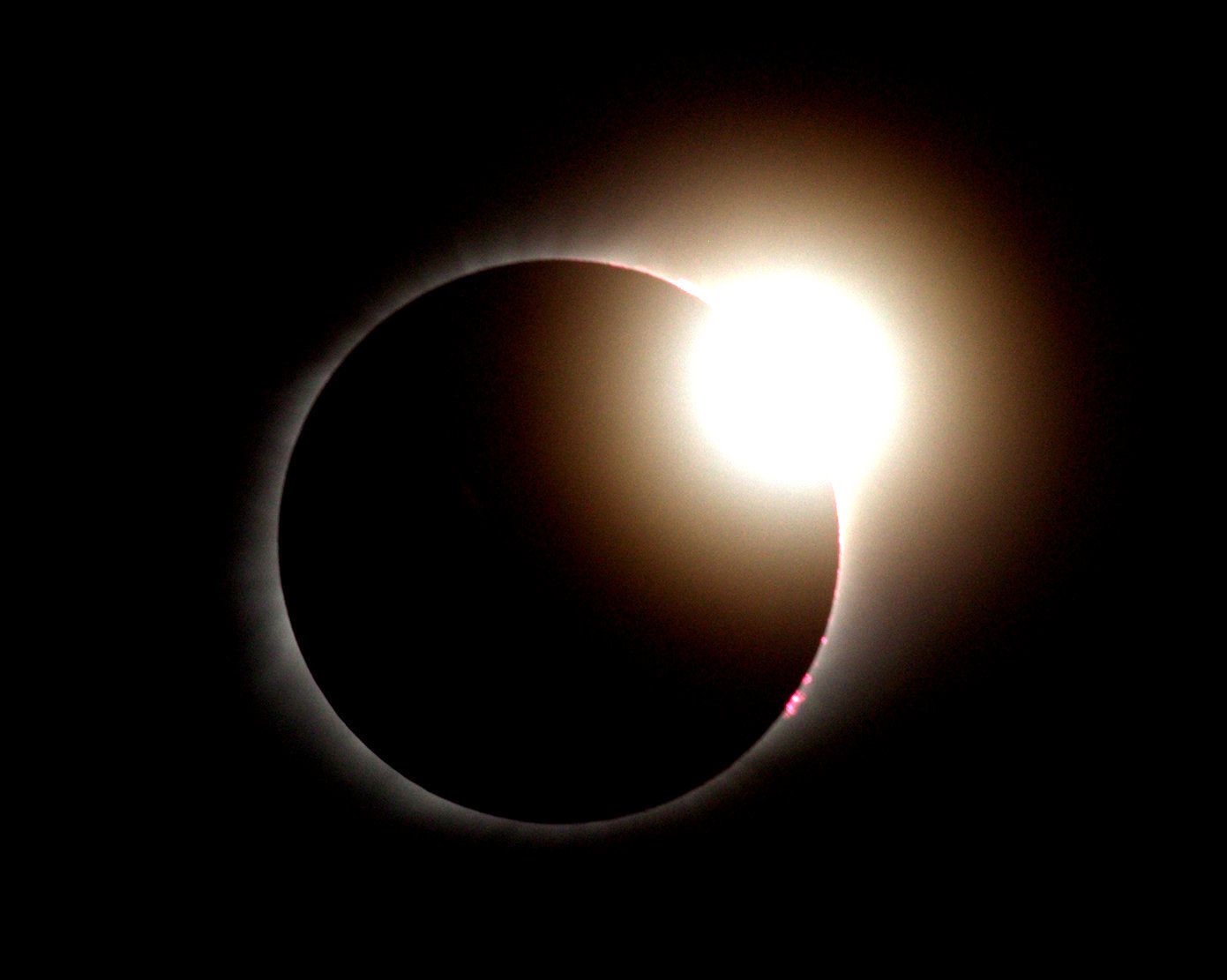 End of solar eclipse with large diamond ring and prominences